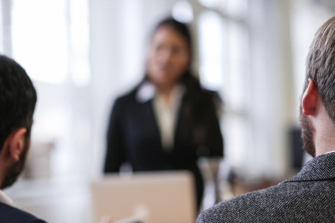 Out of focus woman running a meeting.