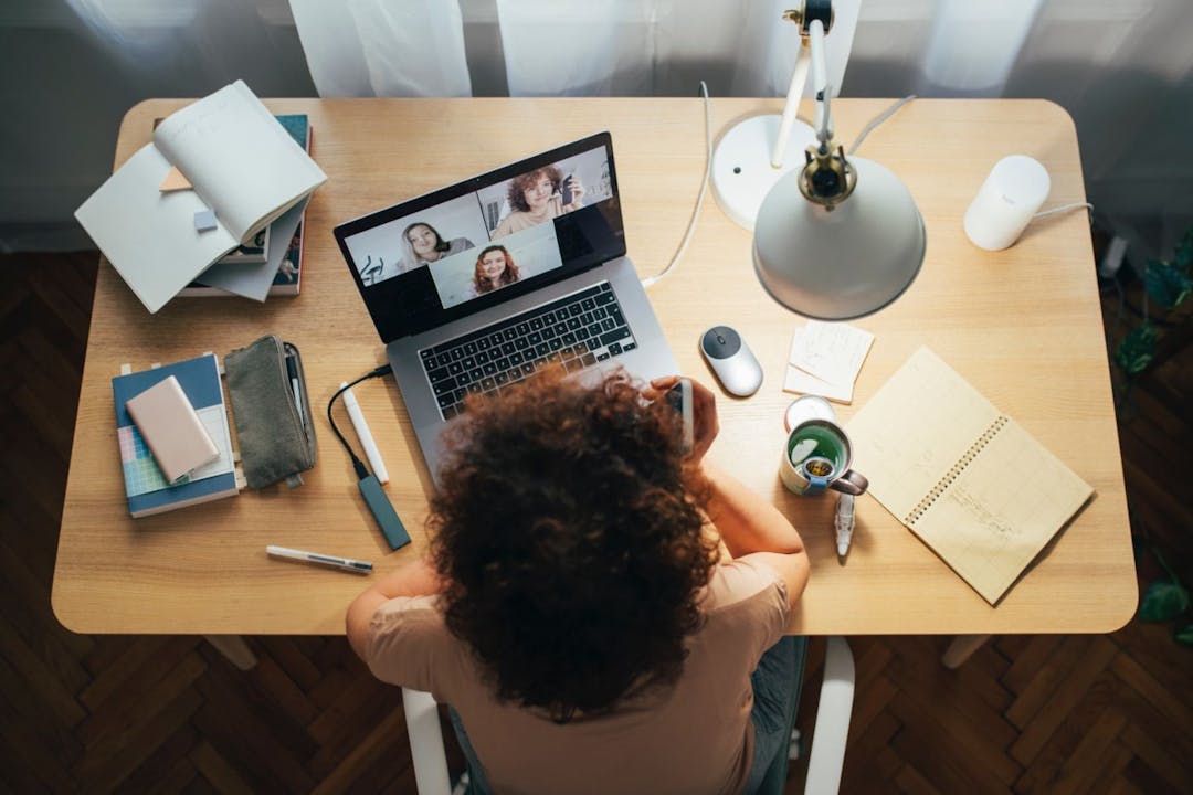 Woman sitting at her desk on a video call.