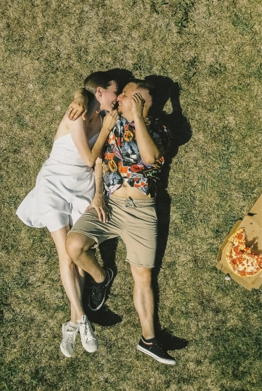 A couple lying on the grass, in love