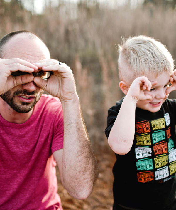 dad and son look through hand goggles