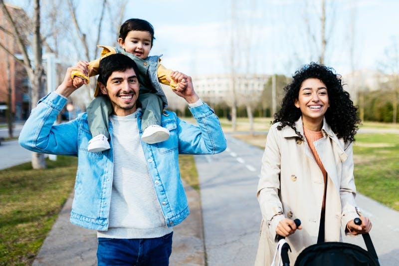 happy family walking after refinancing student loans