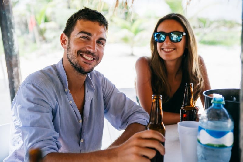 couple enjoying drinks after refinancing student loans